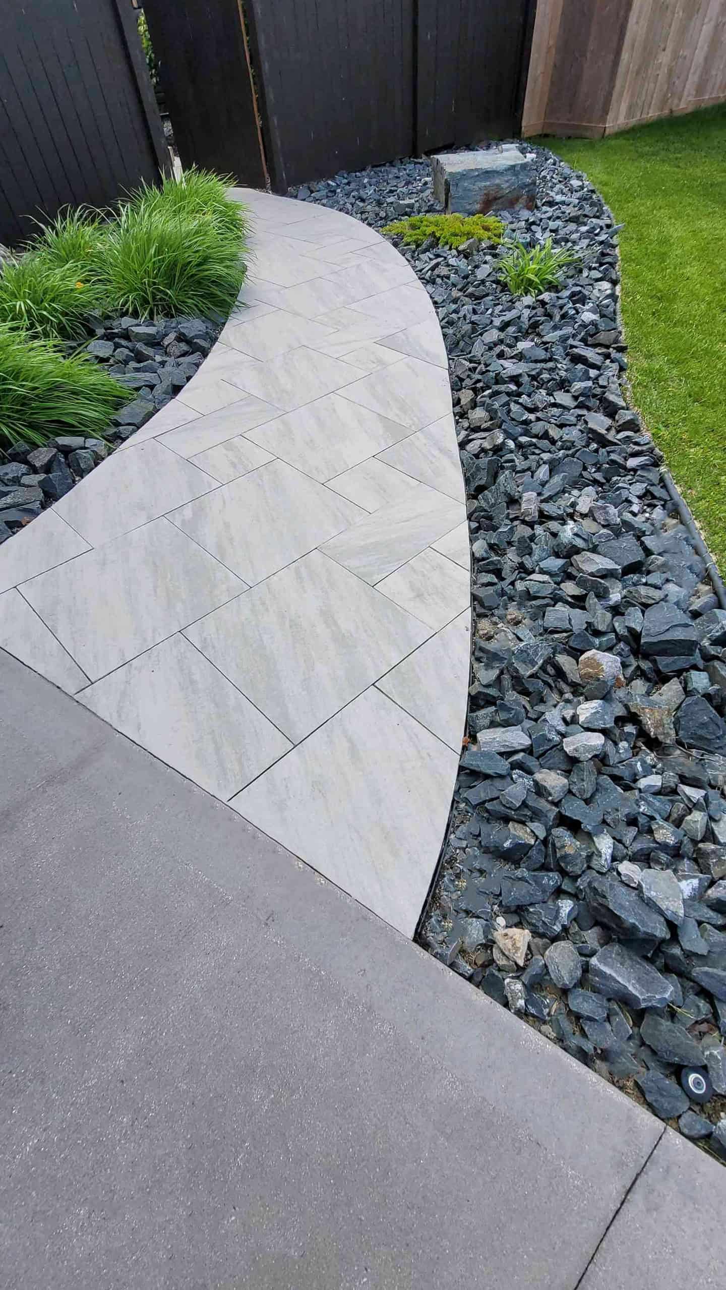 Modern paver walkway with decorative rock border in Deerpoint landscaping project