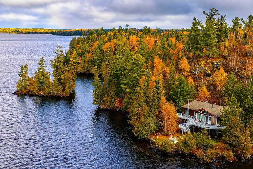 Scenic fall landscape with colorful trees by the lake in Manitoba