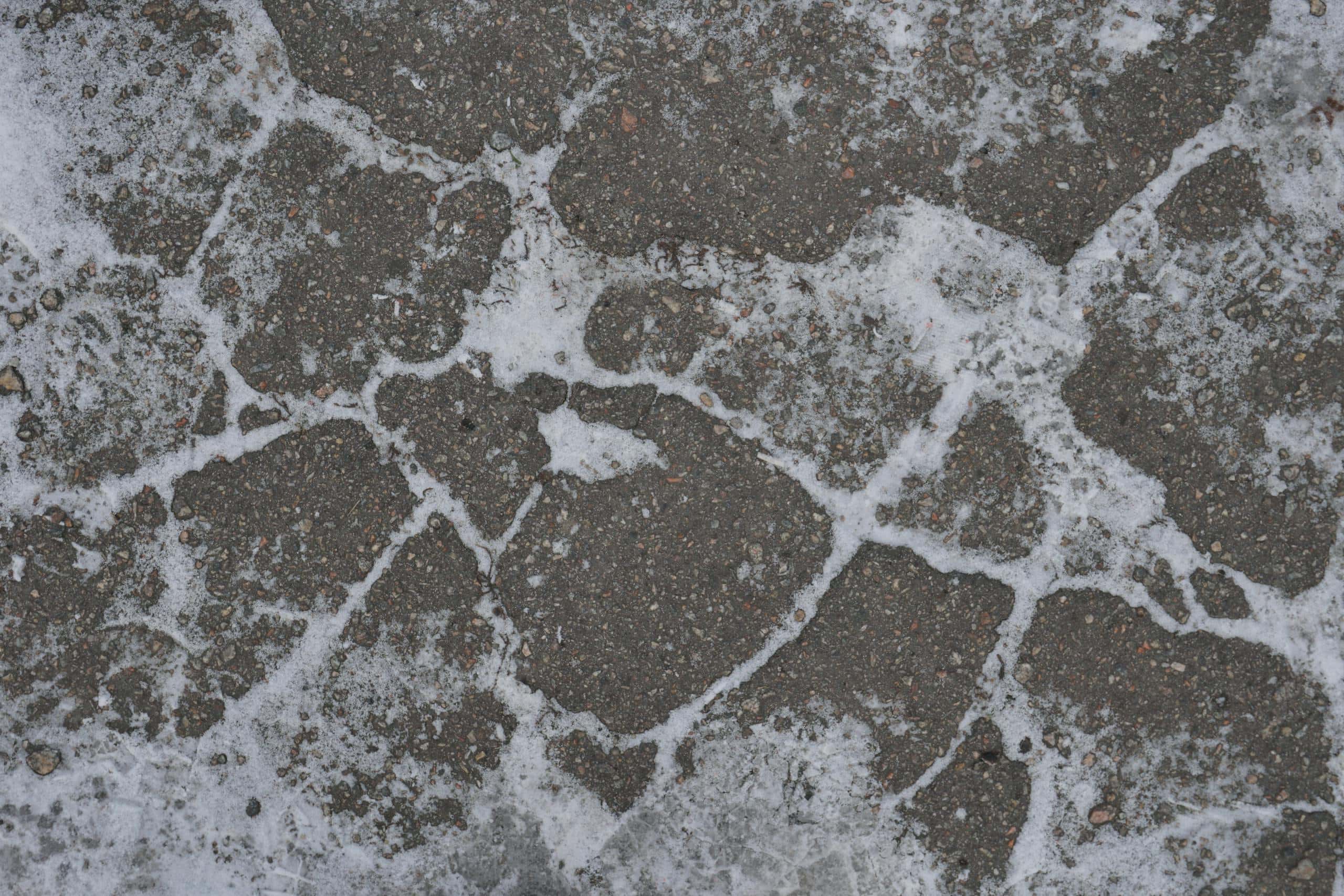 Close-up of a frosty cobblestone pavement, showcasing winter textures.